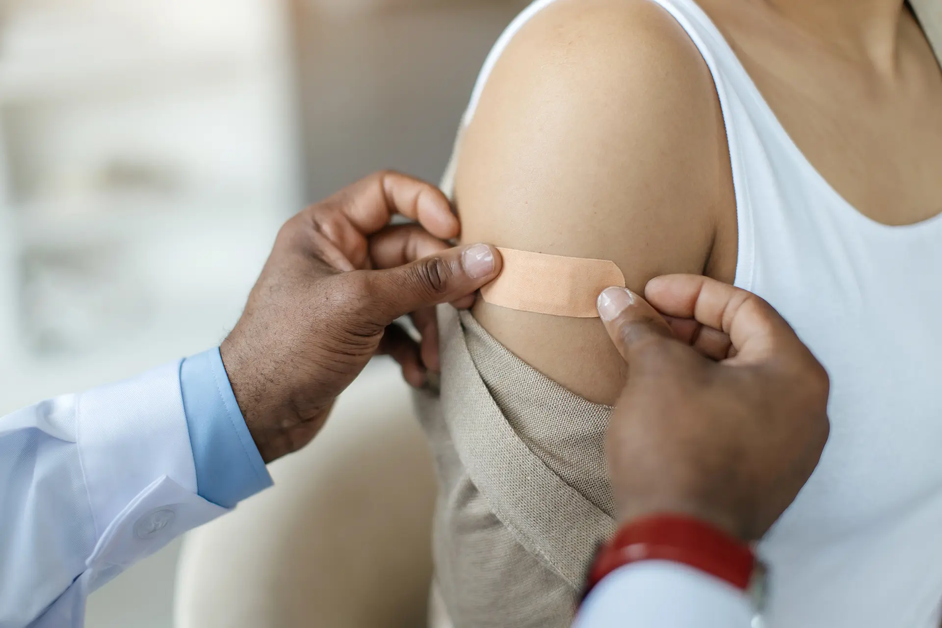 covering up an immunization spot with a bandaid