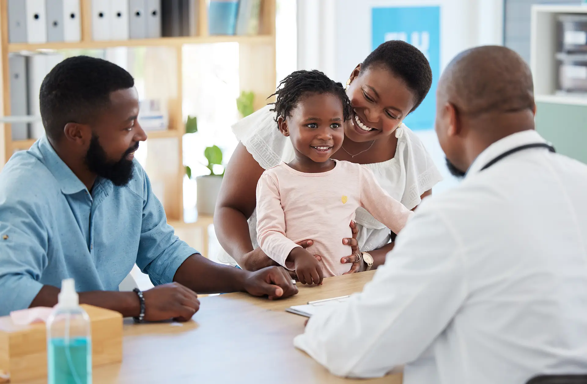 parents with a toddler meeting with doctor